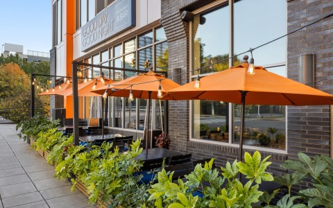 a row of tables and chairs outside of a building