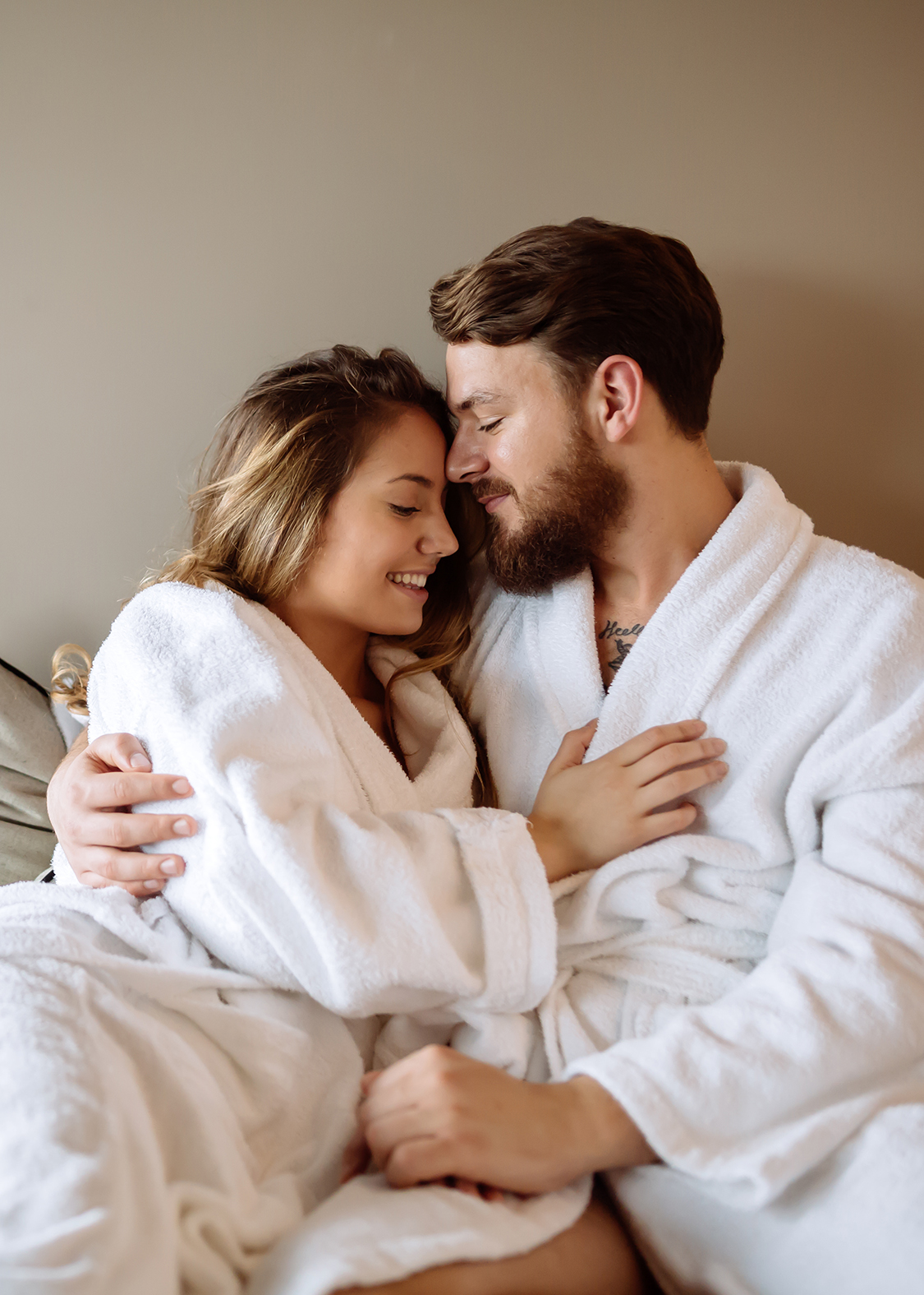 a man and woman in white robes hugging