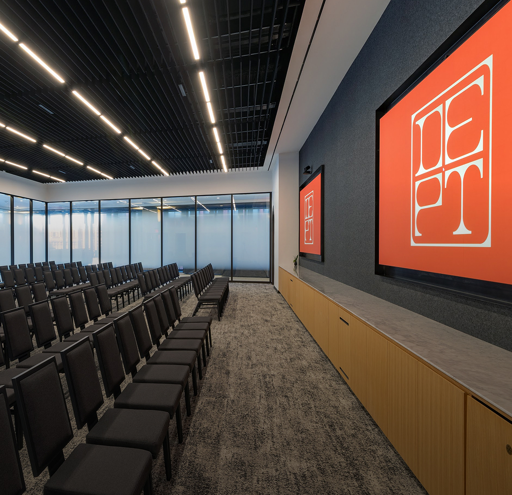 a room with chairs and a screen