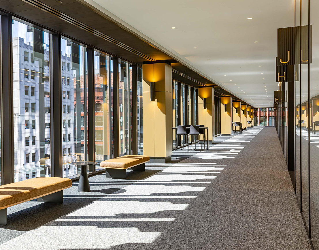 a long hallway with benches and tables
