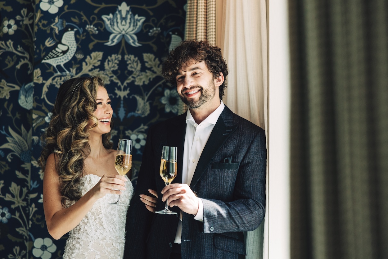 a man and woman holding wine glasses