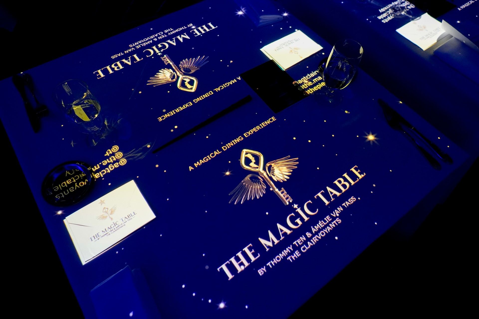 a table with a blue table with a gold and blue tablecloth