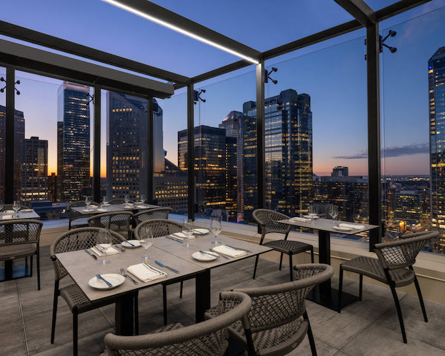 a table and chairs with a view of a city
