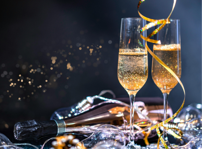 two glasses of champagne with streamers and ribbons