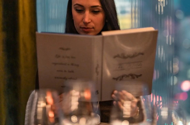 a woman reading a menu