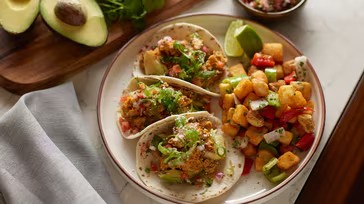 a plate of breakfast tacos and vegetables