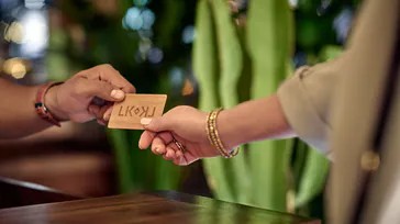 a person handing a card to another person