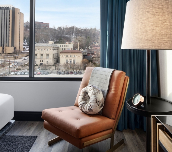 a chair in a room with a lamp and a window