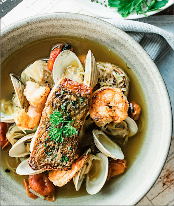 a bowl of soup with seafood