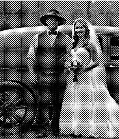 a man and woman standing next to a car