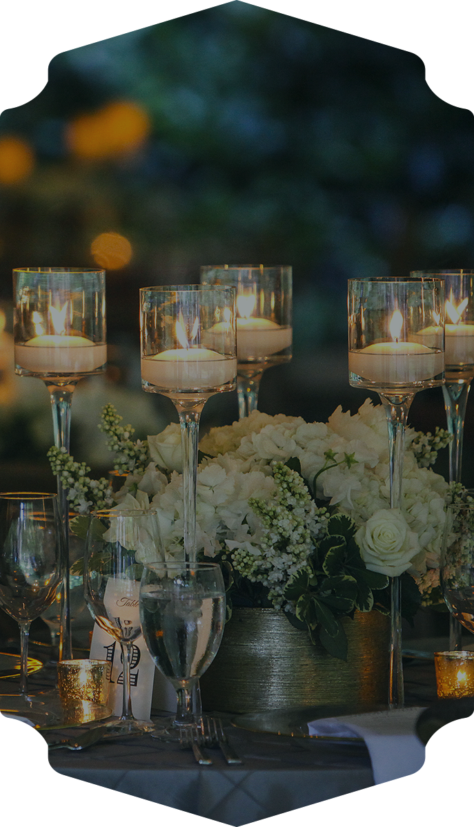 a group of candles in glasses and flowers