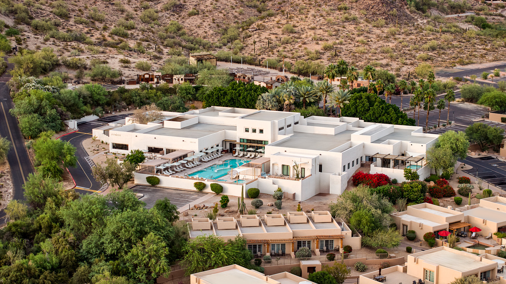 a building with a pool surrounded by trees