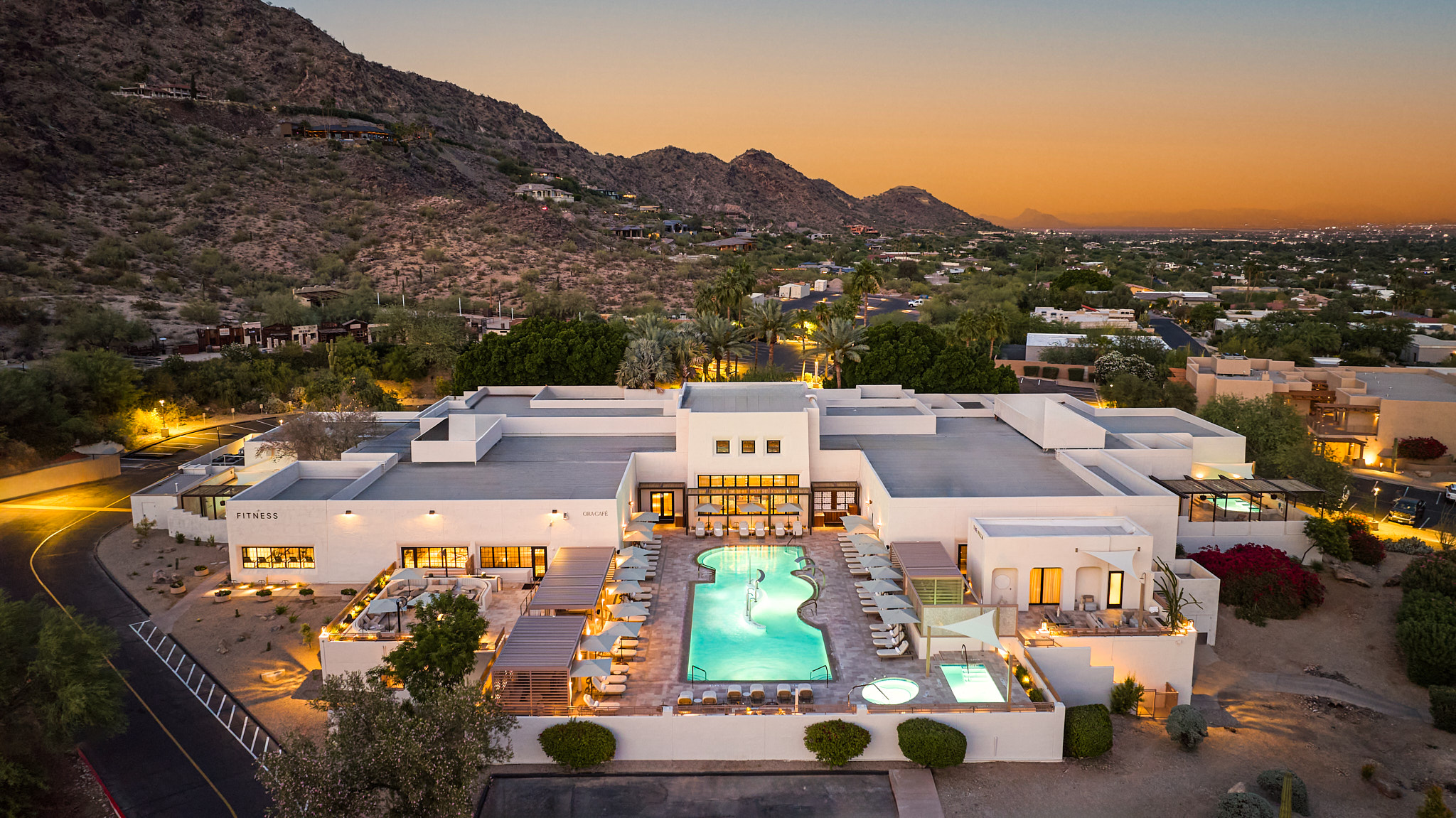 a building with a pool and a mountain in the background