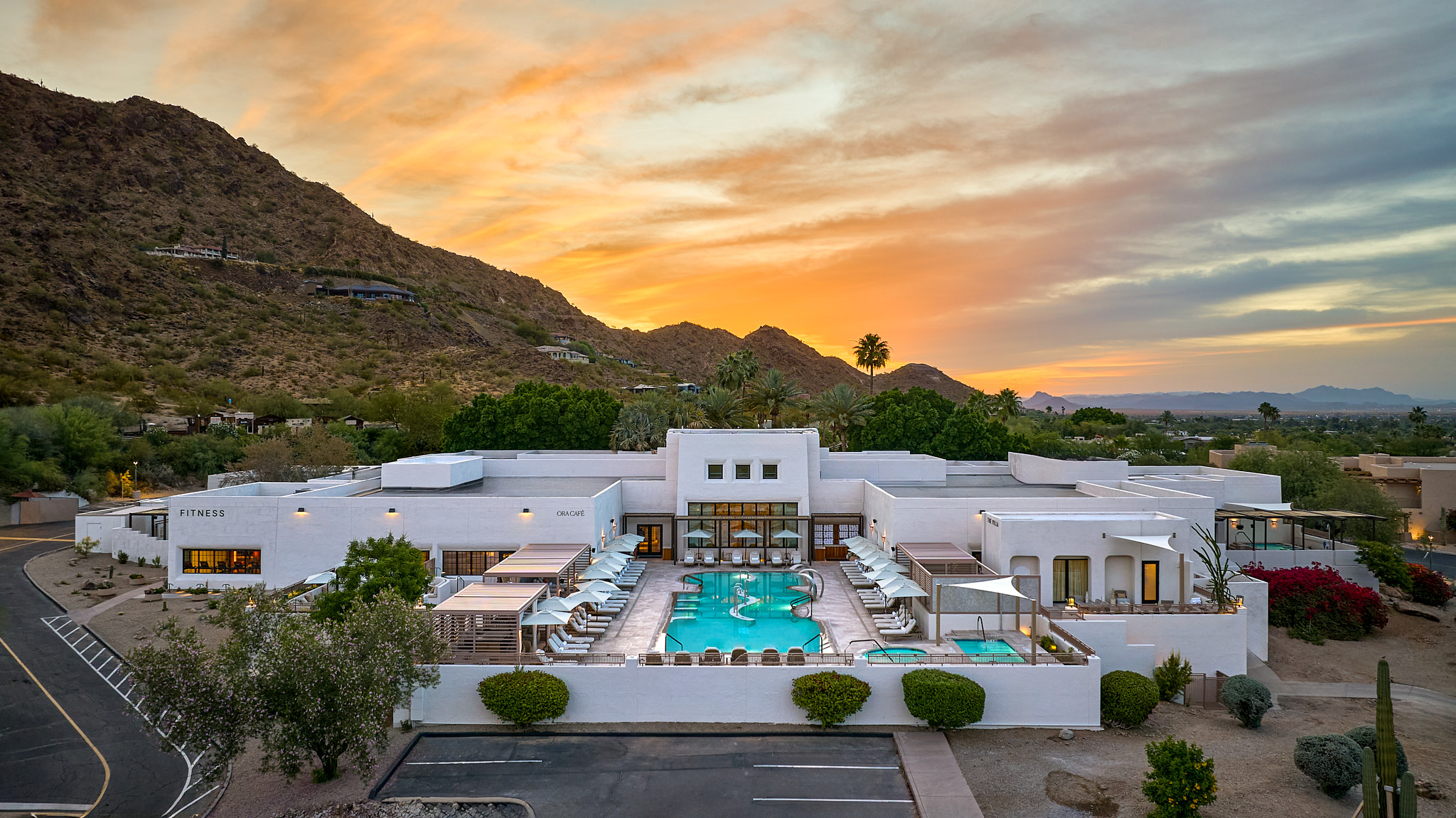 a pool in a building with a mountain in the background
