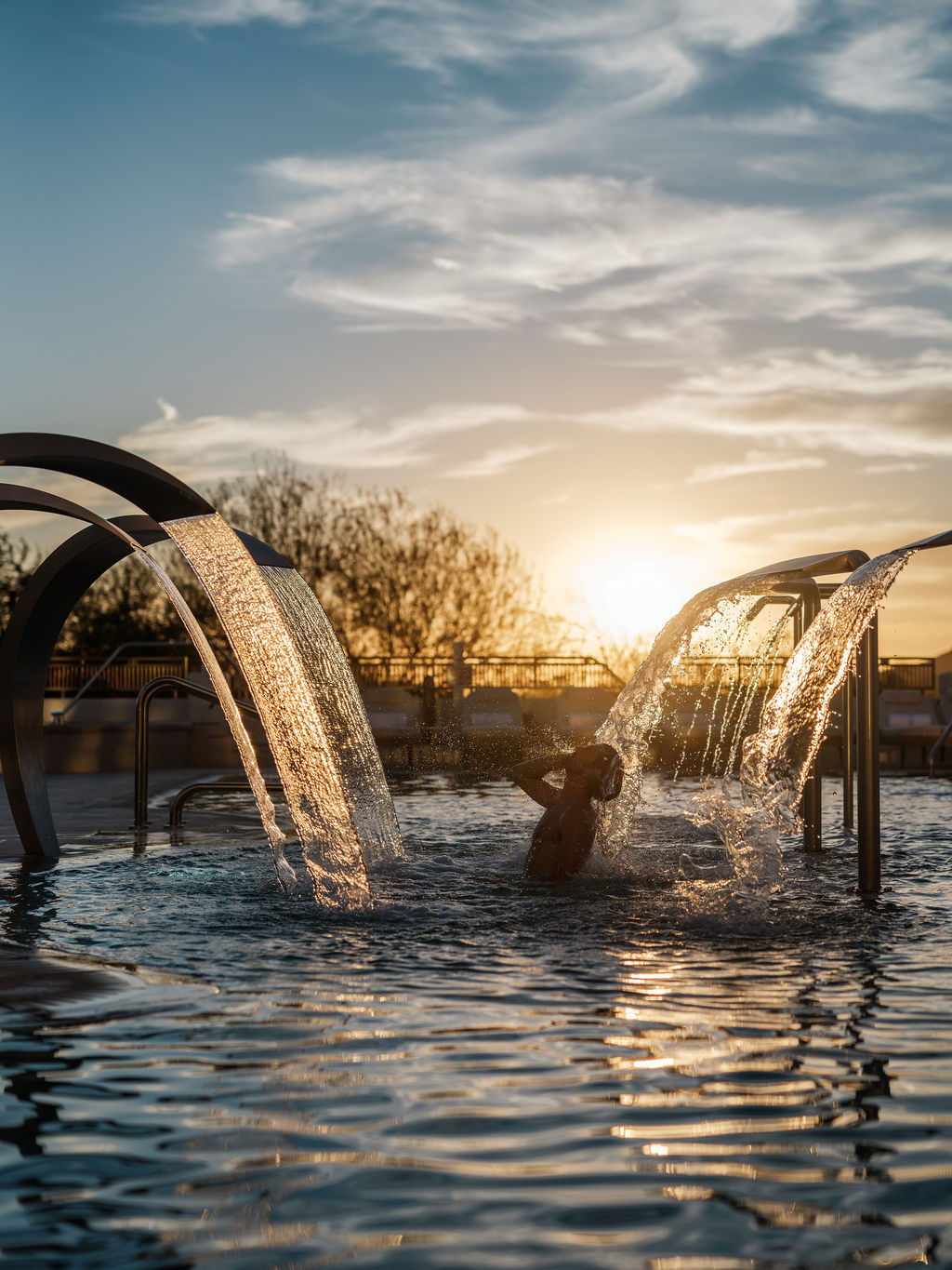a person in a pool with water splashing out of it