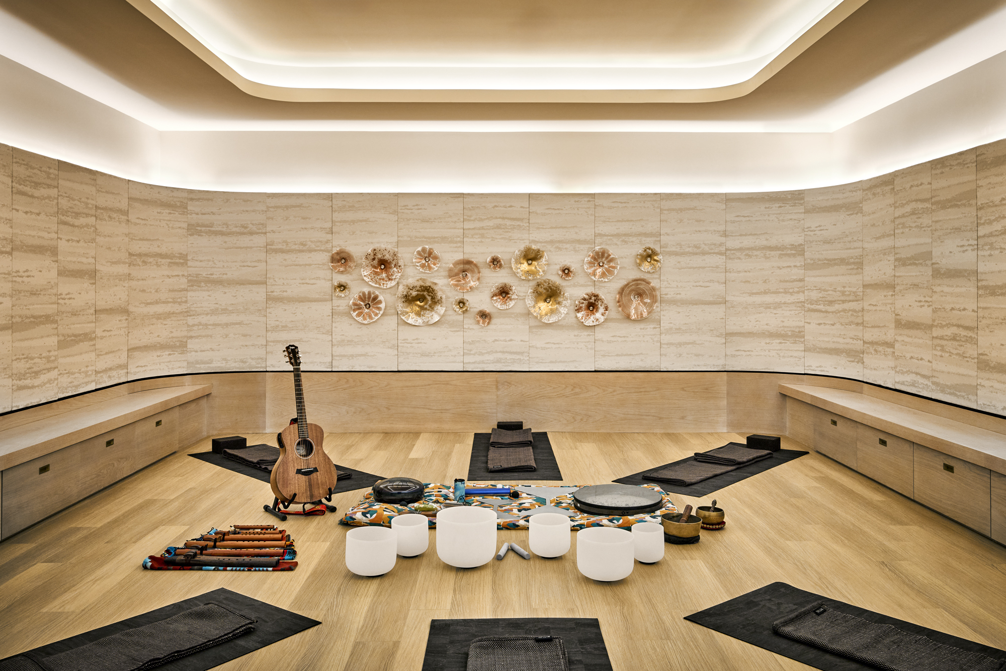 a room with a guitar and bowls on the floor