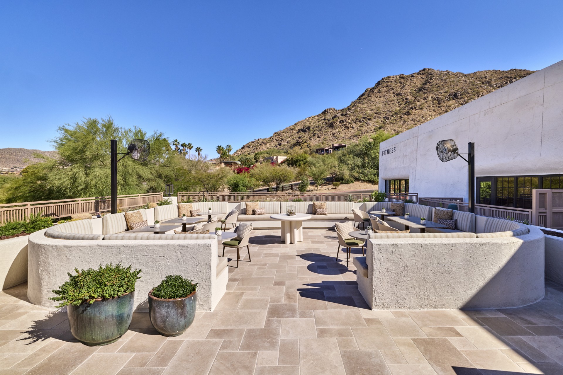 a patio with tables and chairs
