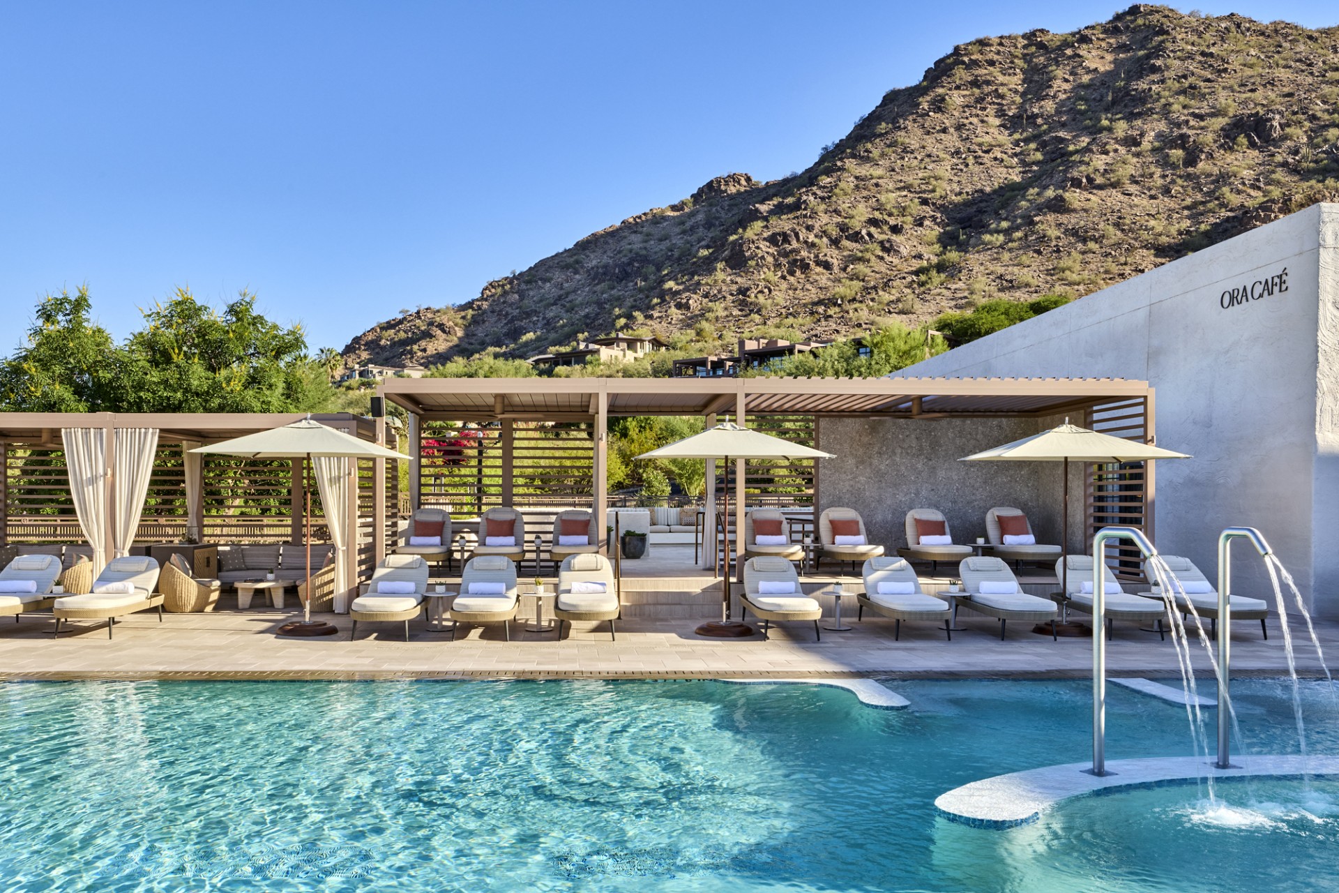 a pool with lounge chairs and umbrellas