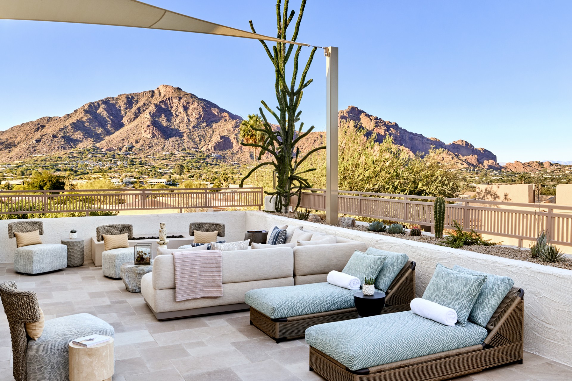 a patio with couches and chairs on a deck