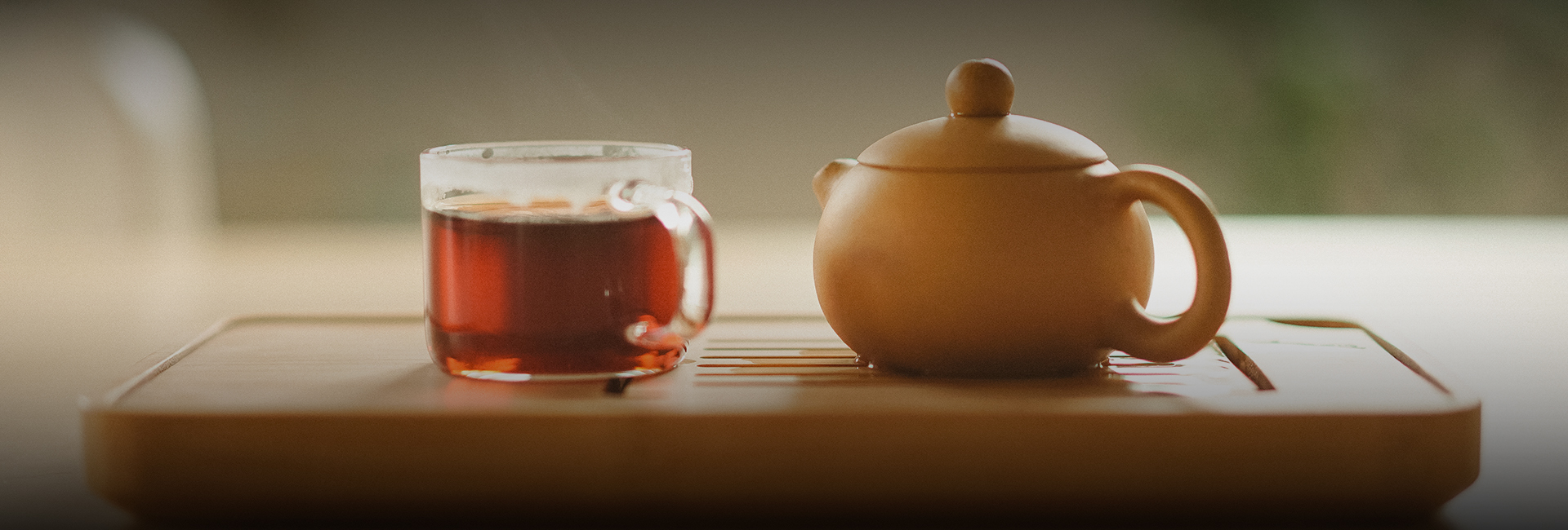 a tea pot and a glass cup