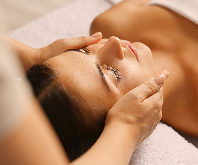 a woman receiving a face massage