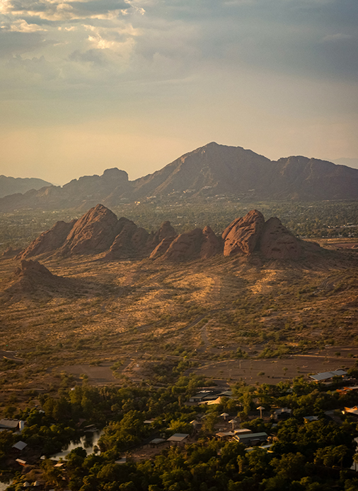 a landscape of a desert with mountains and trees