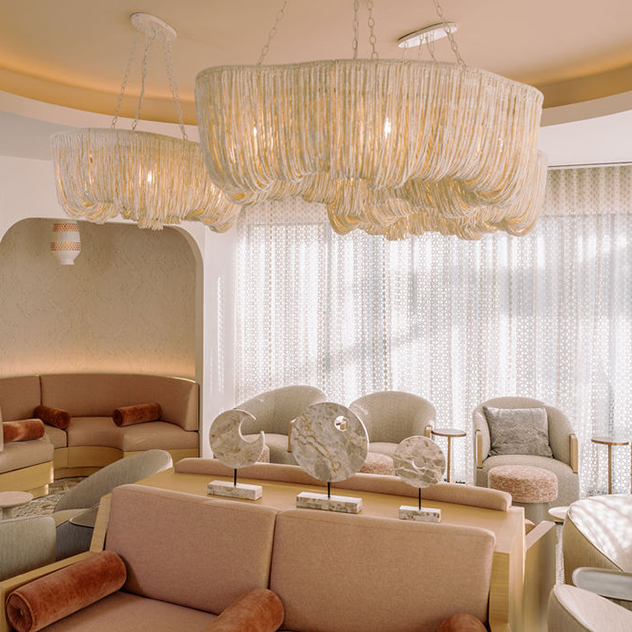 a room with a chandelier and couches