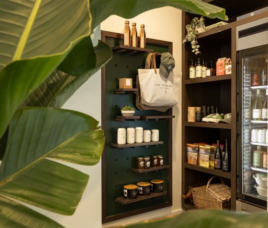 a shelves with various products and a bag on it