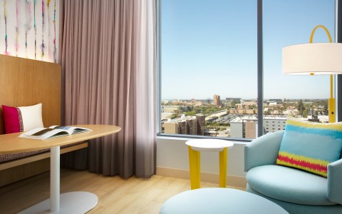a room with a table and chairs and a window