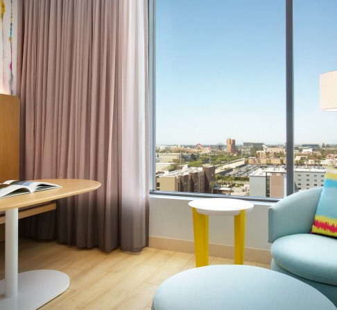 a room with a table and chairs and a window