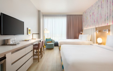 a room with two beds and a tv