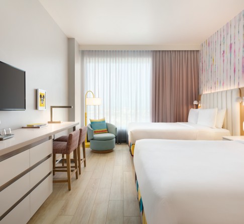 a room with two beds and a tv