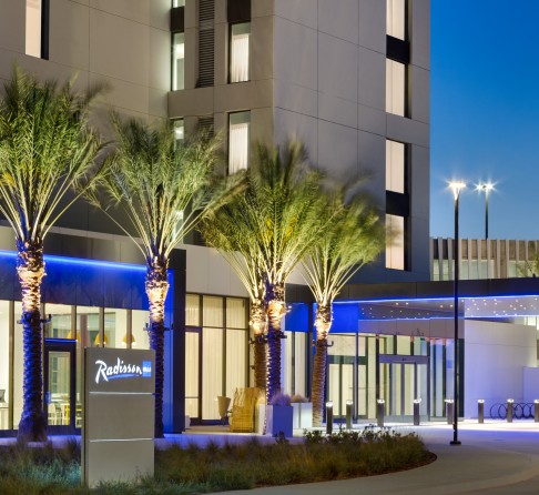 a building with palm trees and a sign