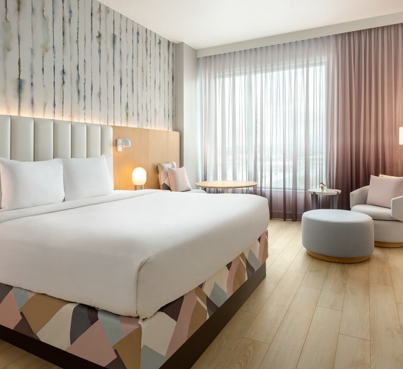 a room with a bed and chairs