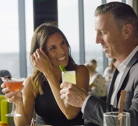 a man and woman holding drinks