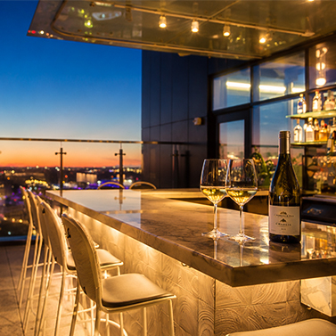a wine glasses and bottles on a bar