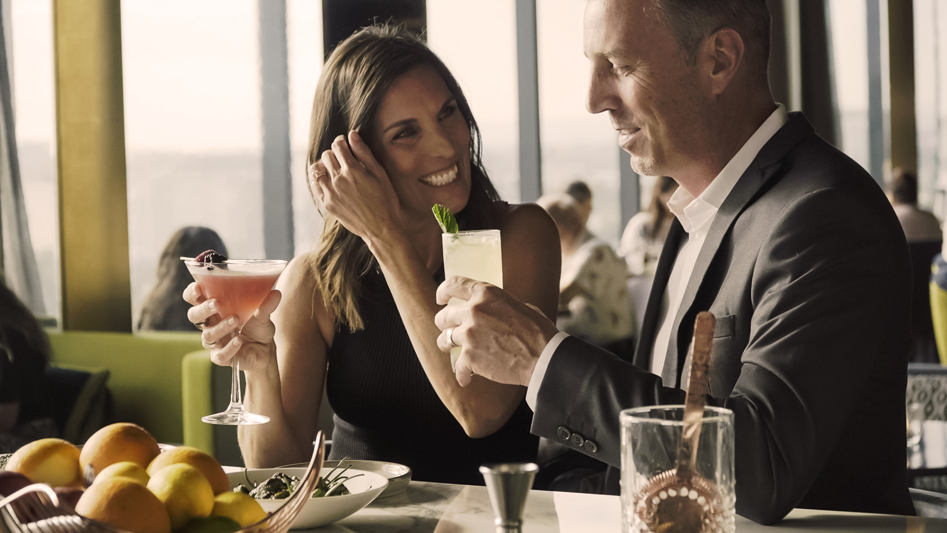 a man and woman holding drinks