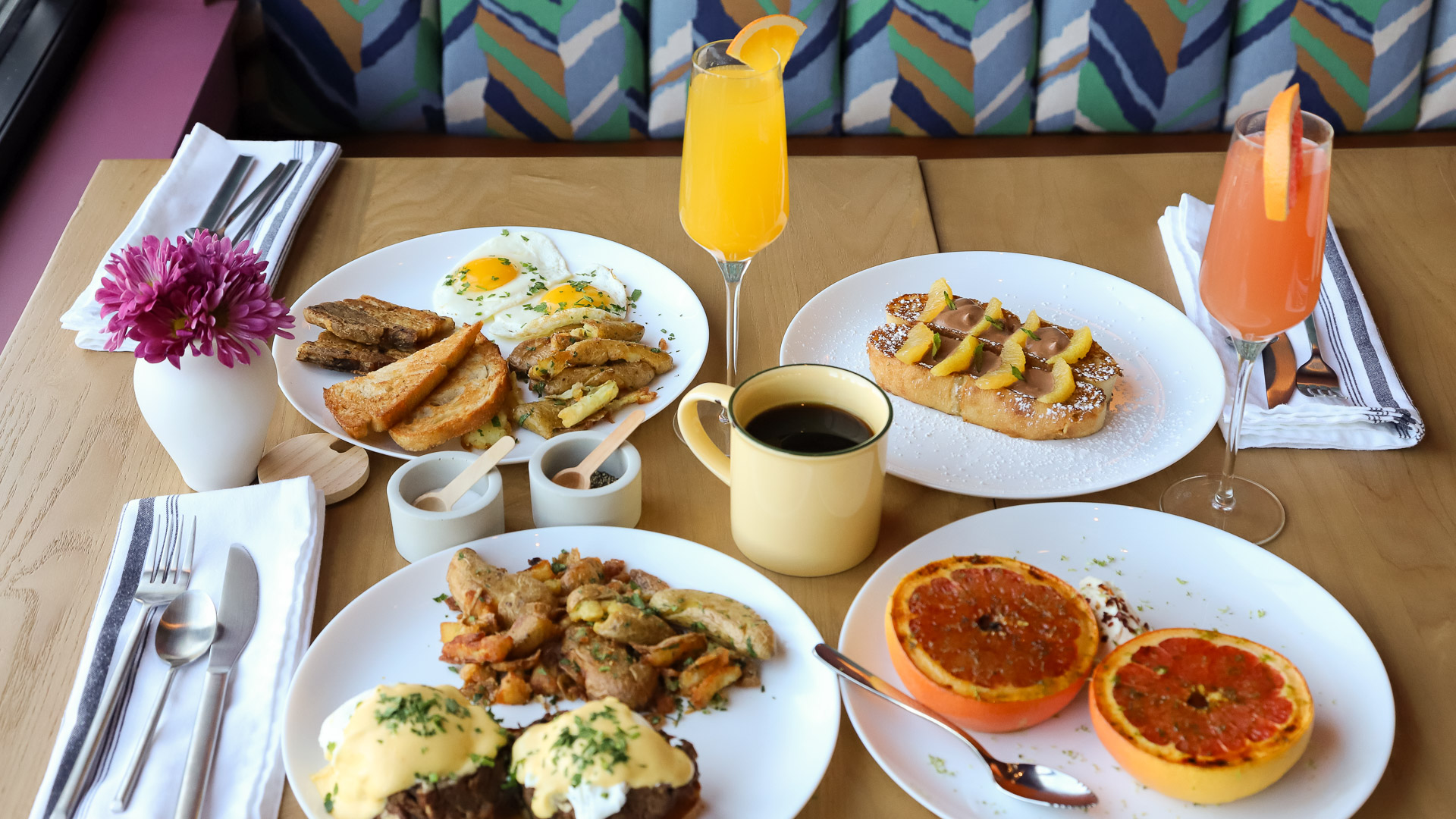 a table with plates of food and a drink