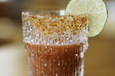 a glass with a drink and a lime slice