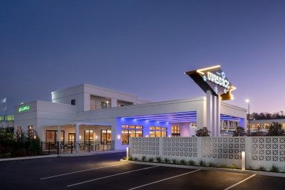 a building with a sign and a parking lot