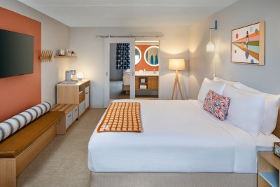 a bedroom with a bed and a mirror