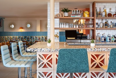 a bar with a counter and chairs