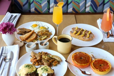 a table with plates of food and a drink