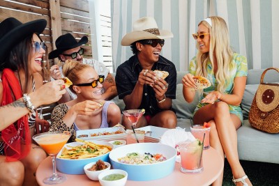 a group of people eating tacos