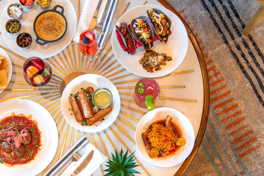 a table with plates of food and drinks