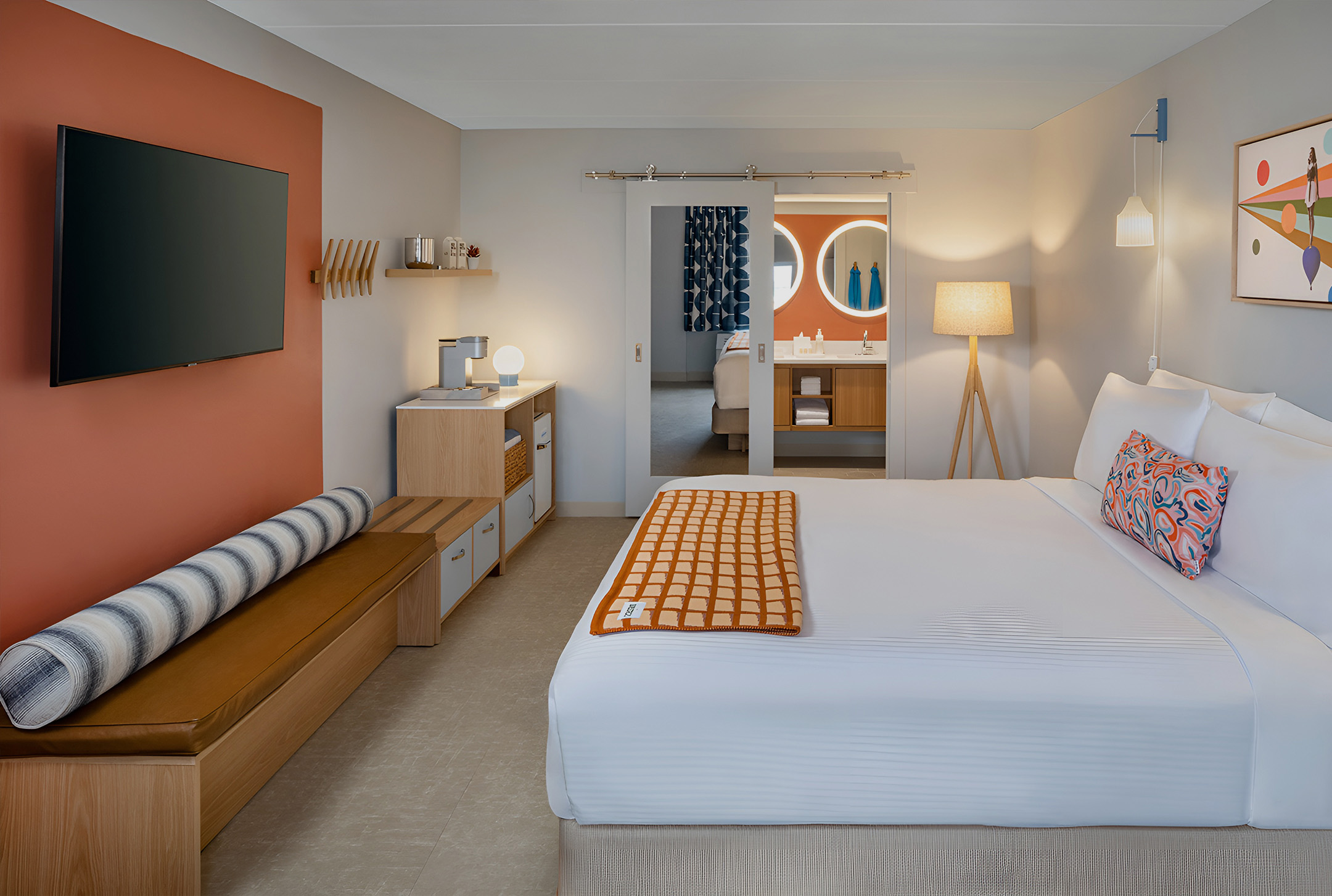 a bedroom with a bed and a mirror